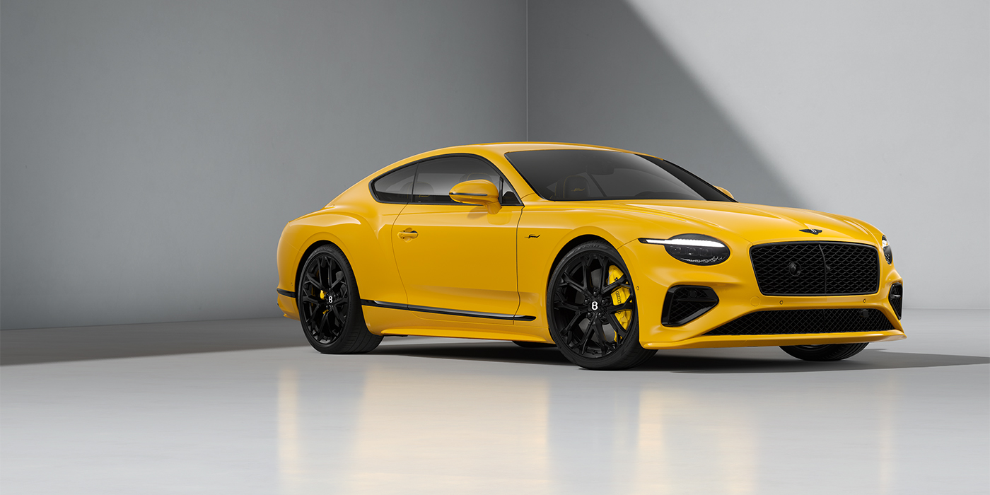 Bentley Köln Bentley Continental GT Speed coupe in Monaco Yellow paint and 22" Ten spoke sport wheels - front 3/4