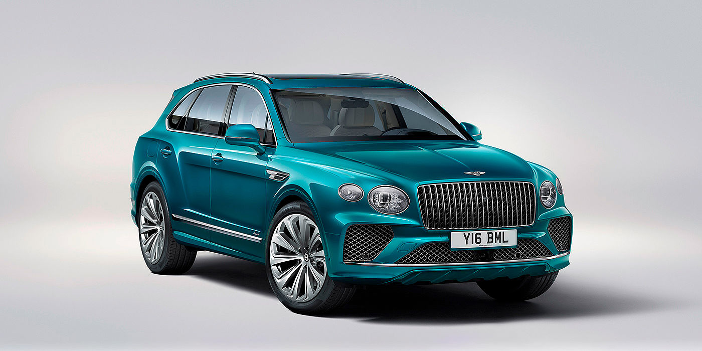 Bentley Köln Bentley Bentayga Azure front three-quarter view, featuring a fluted chrome grille with a matrix lower grille and chrome accents in Topaz blue paint.