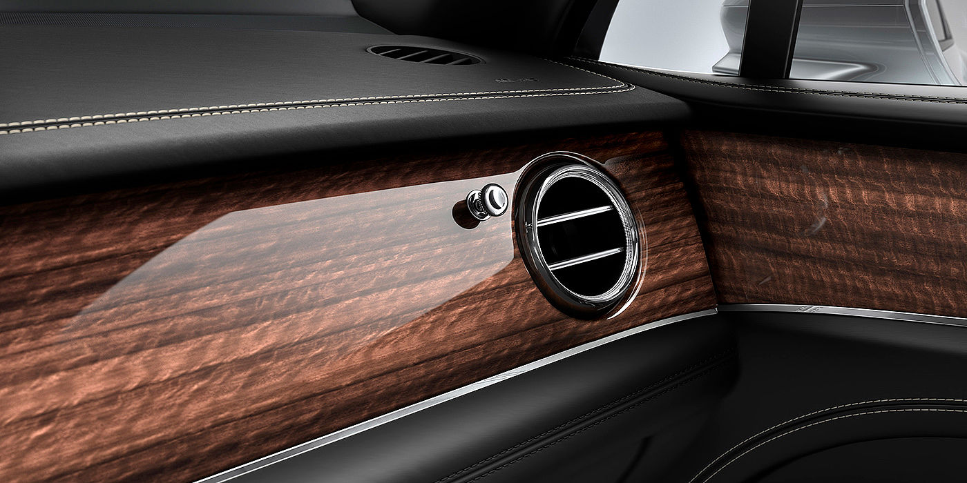 Bentley Köln Bentley Bentayga front interior Crown Cut Walnut veneer and chrome air vent.
