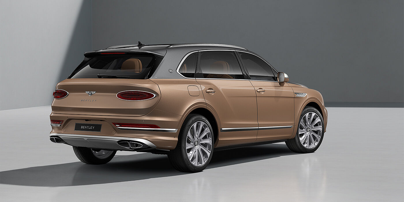 Bentley Köln Bentley Bentayga EWB Mulliner SUV in Magnetic and Rose Gold paint and 22" Mulliner wheels rear ¾