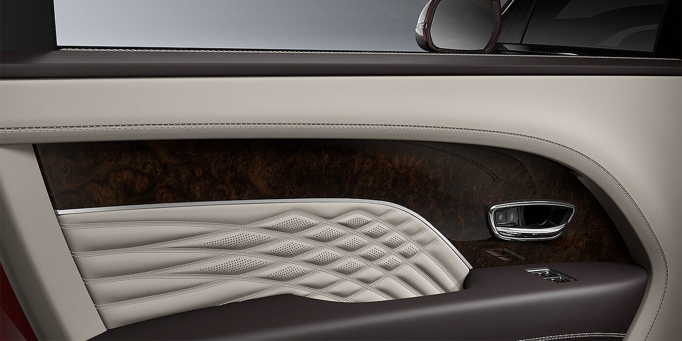 Bentley Köln Bentley Bentayga EWB Azure SUV door interior detail in Linen and Burnt Oak hides with Dark Stained Burr Walnut veneer