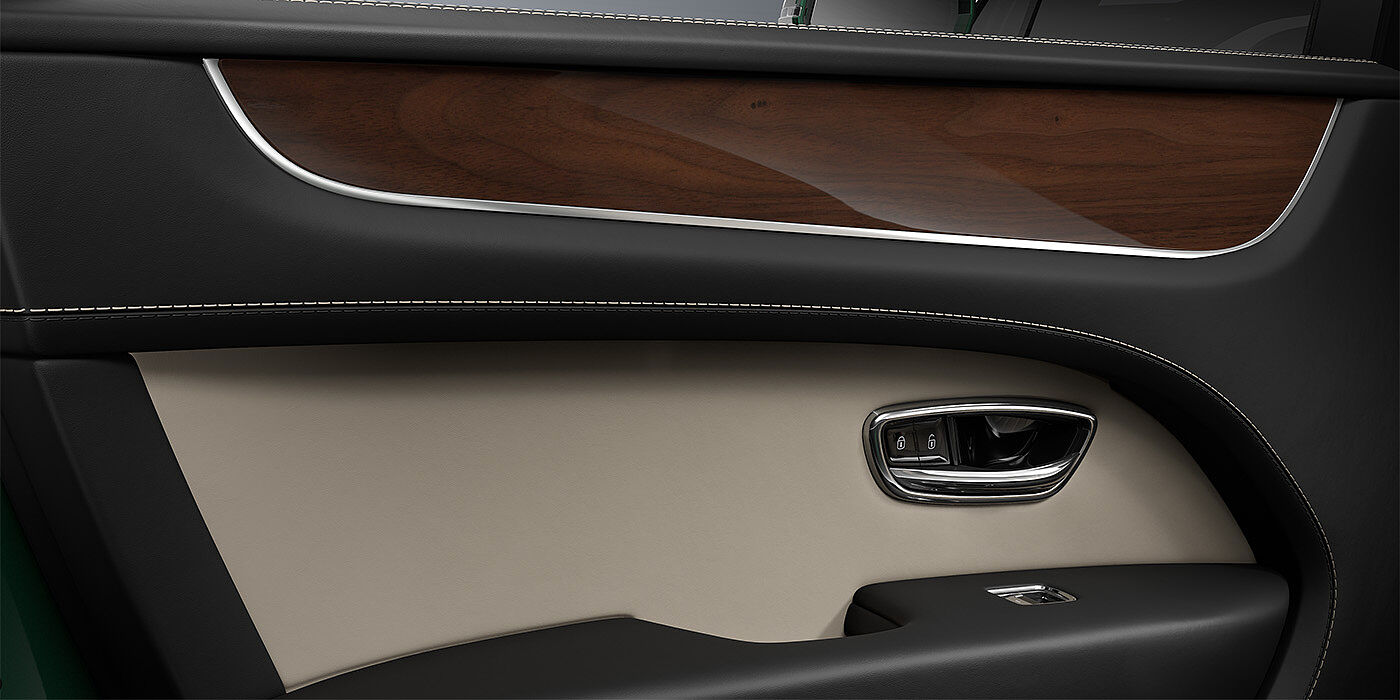 Bentley Köln Bentley Bentayga SUV door interior detail in Portland and Beluga black hides with Crown Cut Walnut veneer
