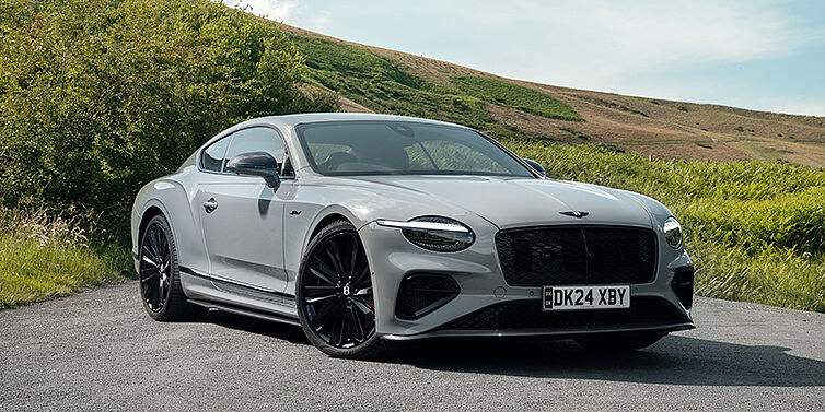 Bentley Köln Bentley Continental GT front three quarter with Carbon Fibre Specification parked on road.