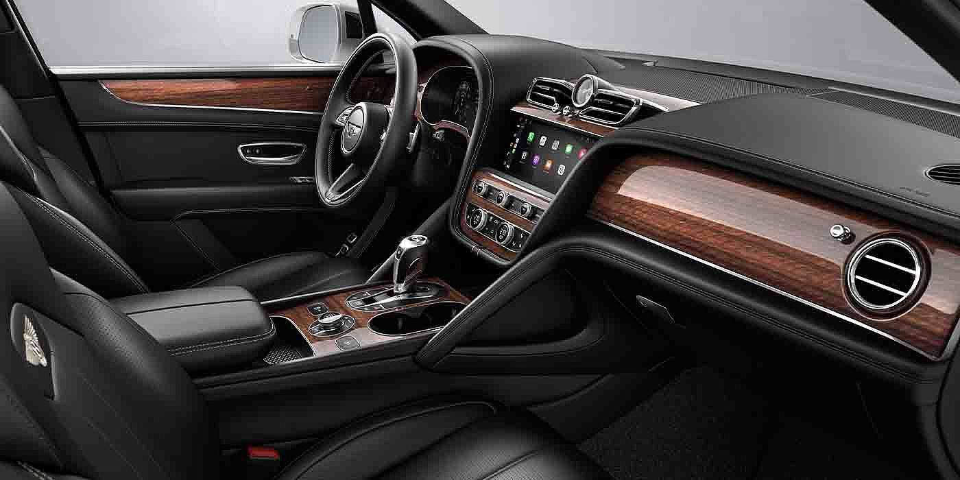 Bentley Köln Bentley Bentayga EWB interior with a Crown Cut Walnut veneer, view from the passenger seat over looking the driver's seat.