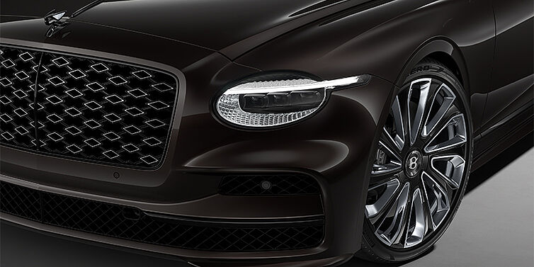 Bentley Köln New Bentley Flying Spur Mulliner sedan head lamp against Havana brown paint with  22" Mulliner Black Painted & Polished wheel