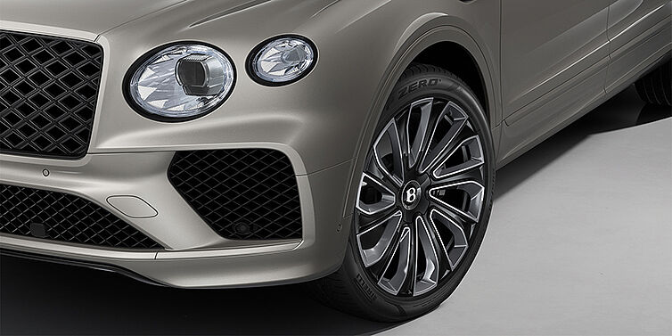 Bentley Köln Bentayga EWB Artenara Edition SUV in Pale Brodgar paint with 22" Mulliner Gloss black wheel close up