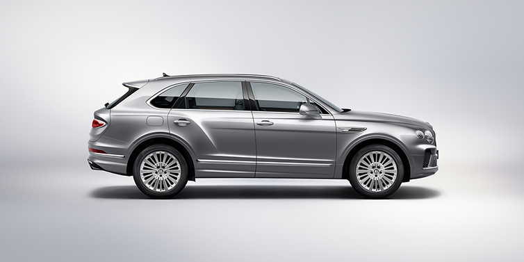 Bentley Köln Bentley Bentayga SUV side profile in Moonbeam silver paint against white background featuring 21 inch 5 spoke wheels