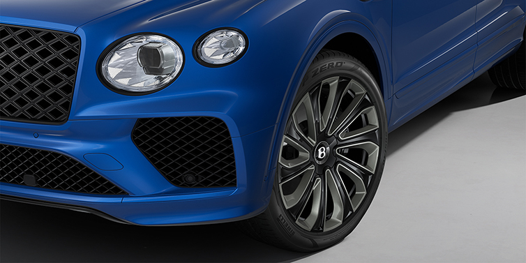 Bentley Köln Bentley Bentayga Artenara Edition SUV front detail in Sequin Blue paint and 22" Mulliner Gloss Black wheels front 3/4