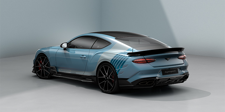 Bentley Köln Bentley Supersports rear three quarter in "Daybreak" Design theme with Jetstream blue paint and Arctica white and Portofino blue paint stripes across the rear haunch.